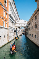 Fototapeta na wymiar Bridge of Sighs and gondola on canal in Venice, Italy