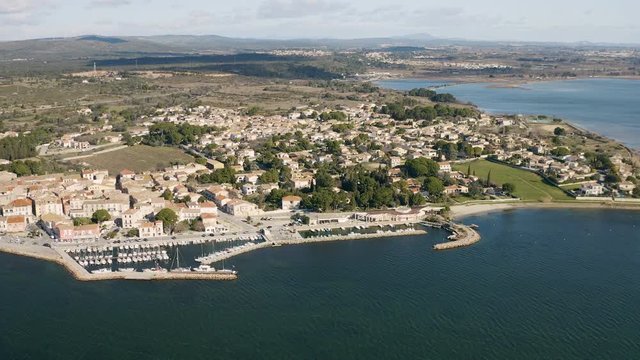 Famous oyster capital Bouzigues town aerial drone shot fishing and sailing harbor Etang de Thau France