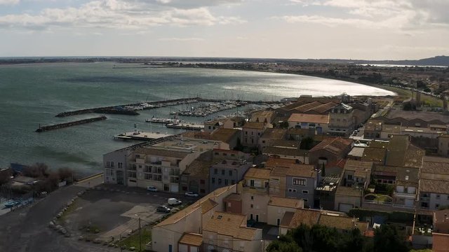 low to medium altitude aerial view discovering Marseillan sailing and fishing port France