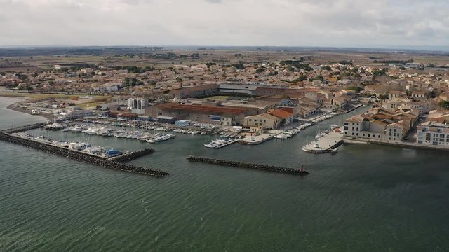 Global aerial view of Marseillan town and port during a sunny windy day Basin de Thau France