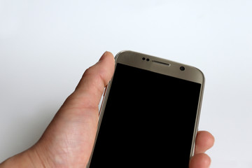 The hand holding the mobile phone.