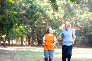 happy Senior couple running in the park
