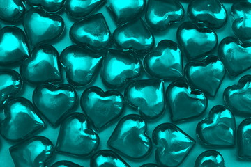 Texture of turquoise hearts on a turquoise background