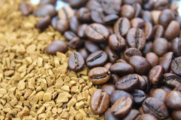 Roasted coffee beans tipped over on white glass