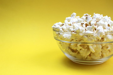 Salted crispy popcorn lies on a glass plate