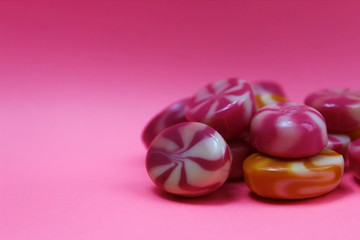 Texture sweet candy caramel on a pink background