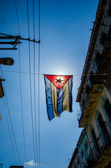 Cuban flag hangs in a street of the working-class neighborhood of Central Havana