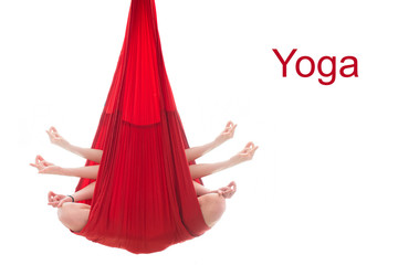 Fly yoga. A girl sits in the lotus position in a red hammock for aerial yoga doing mudras on a...