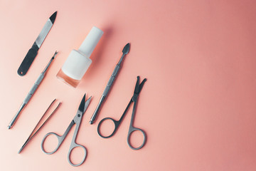 Manicure accessories on a pink background. Top view with copy space.