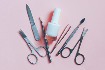 Manicure accessories on a pink background. Top view.