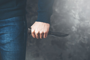 man hand knife on dark background