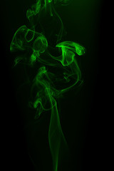 Fototapeta premium Movement of green smoke on black background for art design
