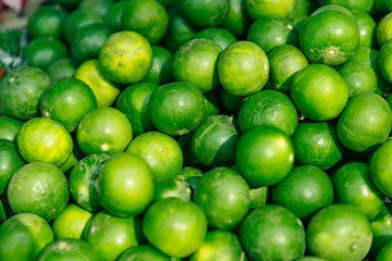 Ingredients Top View, Fresh lime Citrus, green limes background, Manaw is Thai call, top view at Fresh market in Thailand 