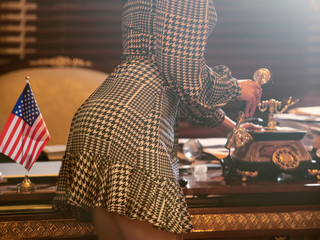 Sexy secretary answer the phone call in boss office. Work romance concept.