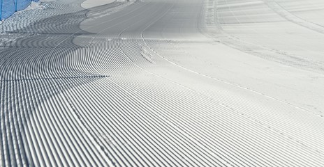 Trace of snow groomer on snow. Snow velvet. Ski and snowboard track. Prepared snow track. Cortina D'Ampezzo, Italy