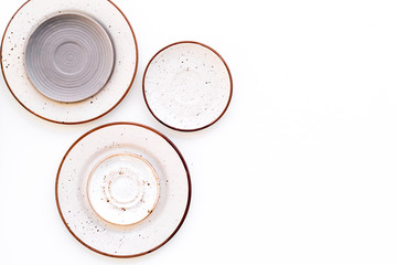 Ceramic plates pattern on white background top view copy space