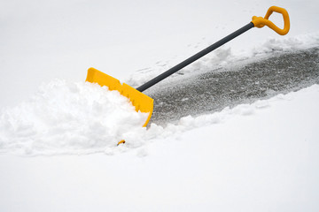 close up on snow shovel removing snow on the driveway © nd700