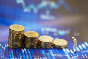 Miniature people:  Businessmen standing with coins stack, Finance, investment and growth in business concept.