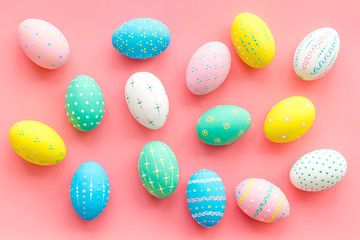 Colorful Easter eggs background on pink top view