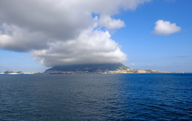 the Rock of gibraltar mountain, city and peninsula with the Marina and blue sky view from the sea
