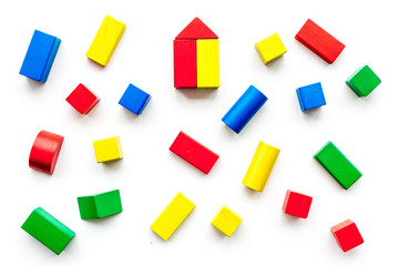 Fototapeta na wymiar Construction game for kids. Wooden building blocks, toy bricks on white background top view