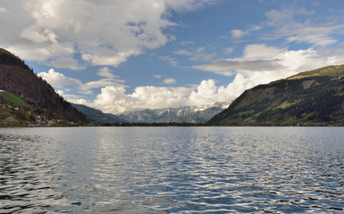 Beautiful spring day in Alps. wonderlust view of highland lake With trees under sunlight and perfect sky. Landscape with Alps and Zeller See in Zell am See, Salzburger Land, Austria