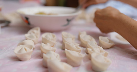 Fototapeta na wymiar Woman make meat dumplings at home for lunar new year