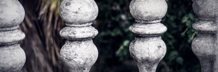 Balusters made of stone on the old historic staircase.
