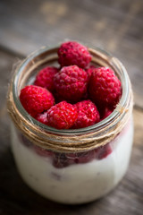 Healthy refreshment breakfast with yogurt, frozen raspberry and chia seeds. Selective focus. Shallow depth of field.