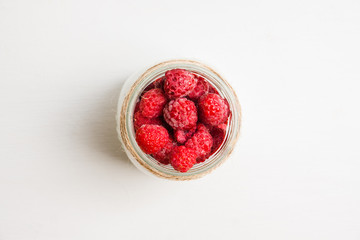 Healthy refreshment breakfast with yogurt, frozen raspberry and chia seeds. Selective focus. Shallow depth of field.