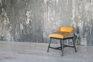 Stool on concrete wall background. Loft room. Wooden floor. daylight. Free space for text.