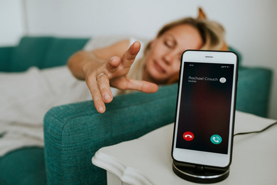 Drowsy Woman Reaching For Her Phone