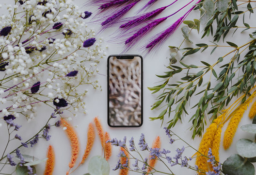 Phone Mockup Framed With A Bunch Of Dried Colorful Flowers