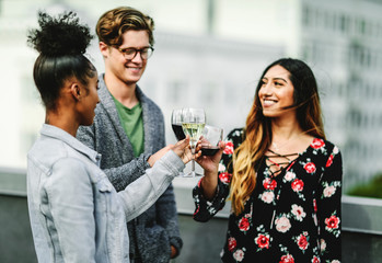 Friends toasting at a rooftop party