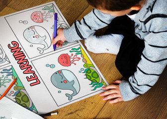 Young boy working on drawing pad network graphic overlay