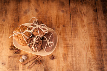 Fototapeta na wymiar Various shortbread, oat cookies, chocolate chip biscuit and spice on dark rustic wooden table.