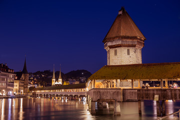 Fototapeta na wymiar Chapel Bridge at night, wooden bridge with grand stone water tower - Luzern, Switzerland