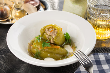 Homemade Meat and Rice Stuffed Bell Peppers with broth served for lunch on the table