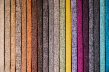 Colorful and bright fabric samples of furniture and clothing upholstery. Close-up of a palette of...