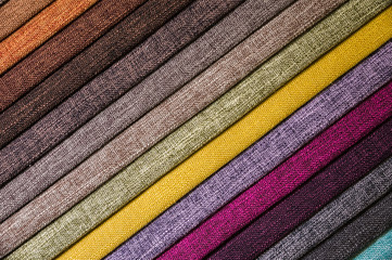 Colorful and bright fabric samples of furniture and clothing upholstery. Close-up of a palette of...