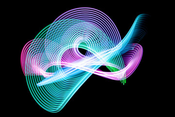 Abstract rainbow neon glowing crossing lines pattern. Dark  background of colorful neon glowing...