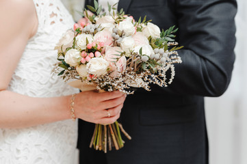 Wedding bouquet in the hands of bride