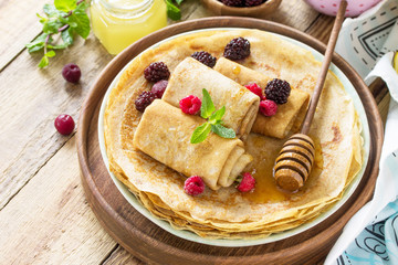 Healthy Pancakes breakfast. Stack of homemade thin pancakes or crepes on a rustic table, served...