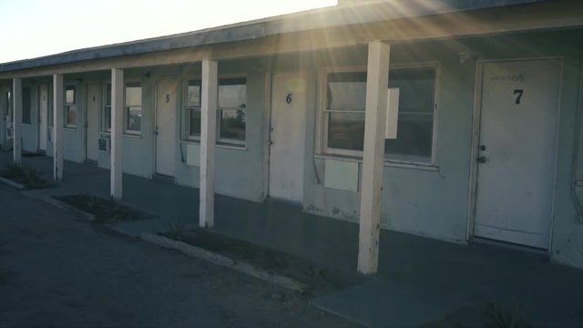 Abandoned hotel in the desert.  Slow move across the numbered doors 