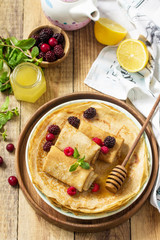 Healthy Pancakes breakfast. Stack of homemade thin pancakes or crepes on a rustic table, served...