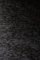 Close up dark grey  brick wall background.