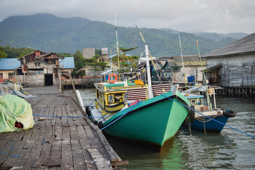 Fototapeta na wymiar fishermen boats in the harbor of settlements
