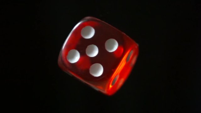 Red dice rotation on black background