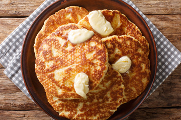 Delicious Sweet Griddle Cakes with butter close-up on a plate. Horizontal top view