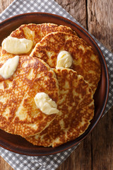 Delicious grilled pancakes with butter close-up on a plate. Vertical top view
